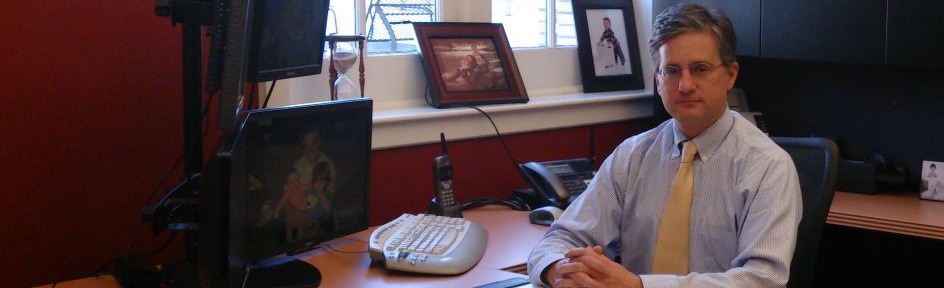 Philip Falco working at his desk in the Equitable Building